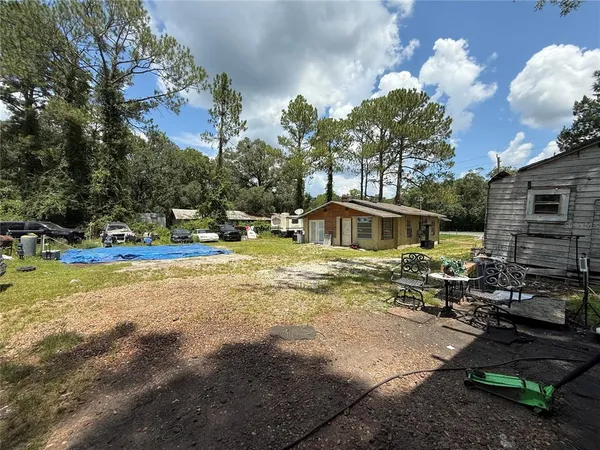 a front view of a house with a yard swimming pool and outdoor seating