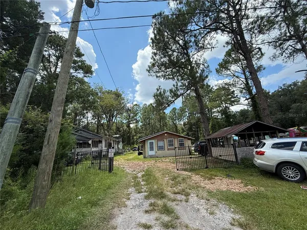 a view of a house with a yard and sitting area