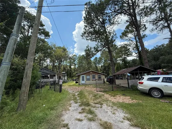a view of car parked in middle of forest