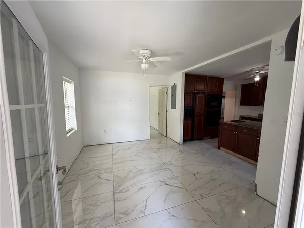 a view of a kitchen with a sink and a refrigerator