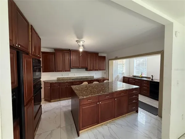 a kitchen with a refrigerator and a sink