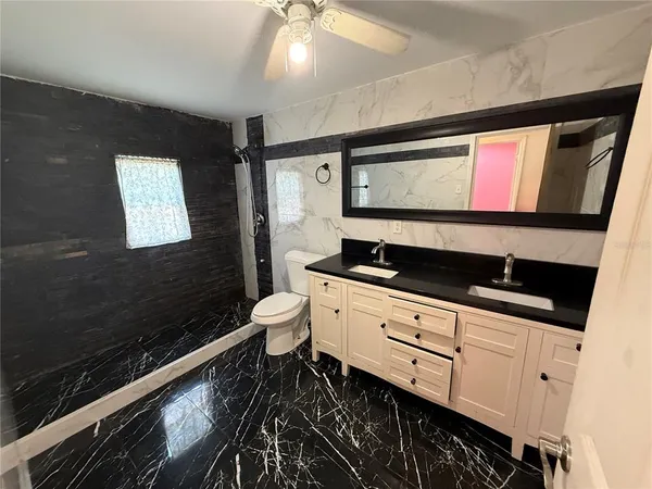 a bathroom with a sink a mirror and a toilet