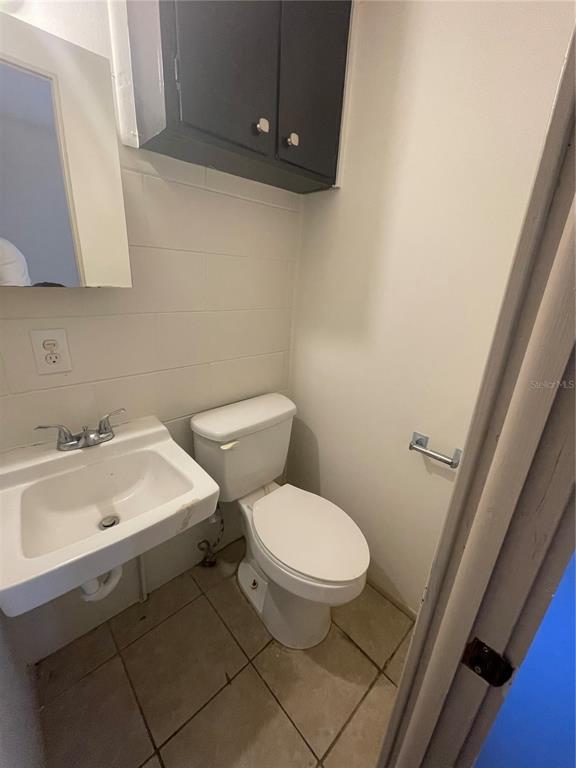 143 East South Street Deland, FL 32724 - Photo 11 of 13 a white toilet sitting next to a bathroom sink