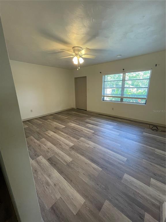 143 East South Street Deland, FL 32724 - Photo 4 of 13 an empty room with wooden floor and windows