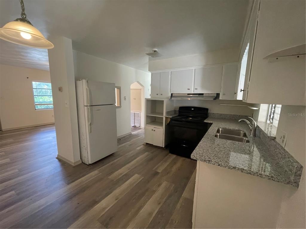 143 East South Street Deland, FL 32724 - Photo 5 of 13 a kitchen with a refrigerator sink and stove