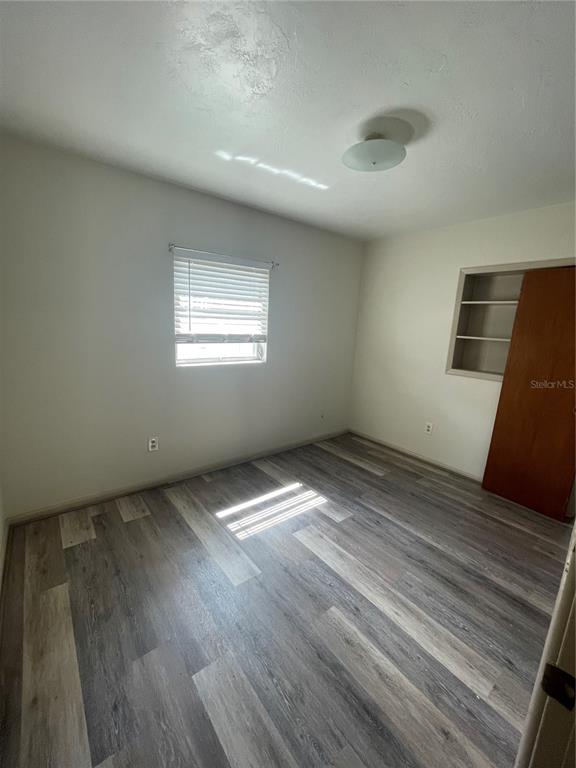 143 East South Street Deland, FL 32724 - Photo 8 of 13 a view of empty room with wooden floor and fan