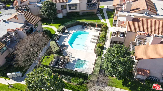 an aerial view of a house with a swimming pool