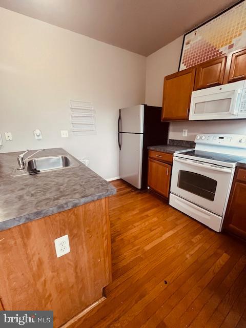 3344 East Baltimore Street, Unit 2 Baltimore, MD 21224 - Photo 3 of 12 a kitchen with granite countertop wooden cabinets and a stove