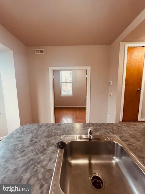 3344 East Baltimore Street, Unit 2 Baltimore, MD 21224 - Photo 5 of 12 a view of a sink a mirror and cabinets in a room