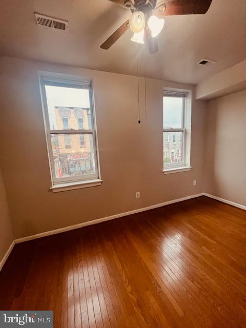 3344 East Baltimore Street, Unit 2 Baltimore, MD 21224 - Photo 6 of 12 a view of an empty room with wooden floor and a window