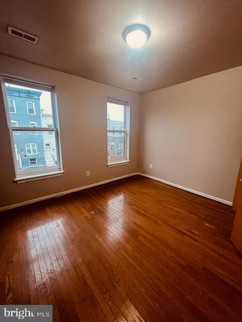 3344 East Baltimore Street, Unit 2 Baltimore, MD 21224 - Photo 9 of 12 a view of an empty room with wooden floor and a window