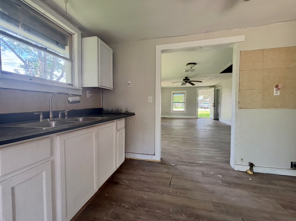 701 North Hackberry Street Sweeny, TX 77480 - Photo 8 of 12 a kitchen with granite countertop a sink and cabinets