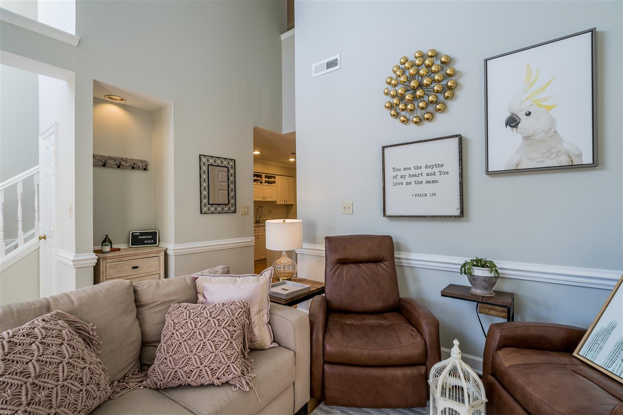 7010 Sandy Forks Road, Unit 207 Raleigh, NC 27609 - Photo 9 of 27 Open living room features vaulted ceilings, recent laminate hardwoods, neutral paint, and a wood burning fireplace! Living Room