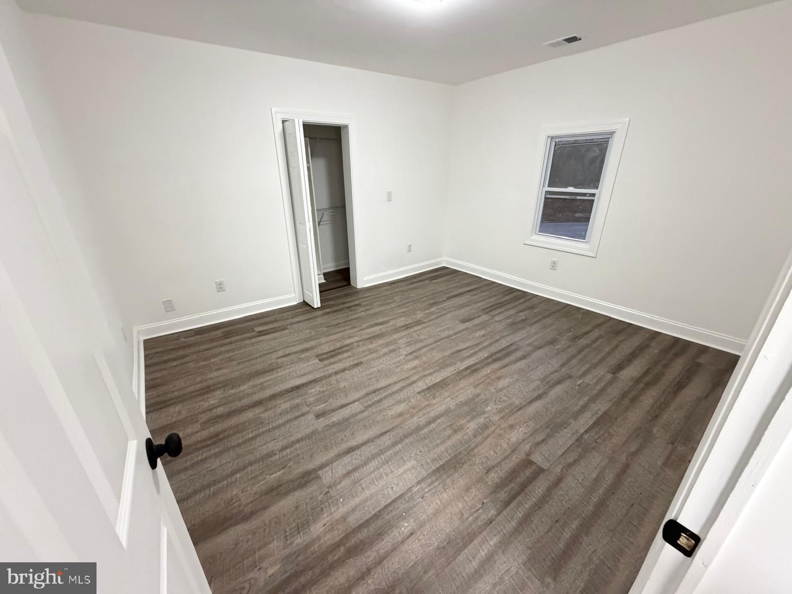 959 Golf Course Road Martinsburg, WV 25404 - Photo 17 of 35 an empty room with wooden floor and windows
