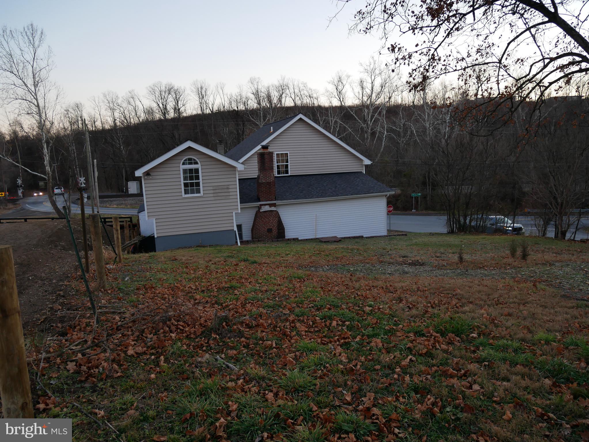 959 Golf Course Road Martinsburg, WV 25404 - Photo 29 of 35 a house with trees in the background