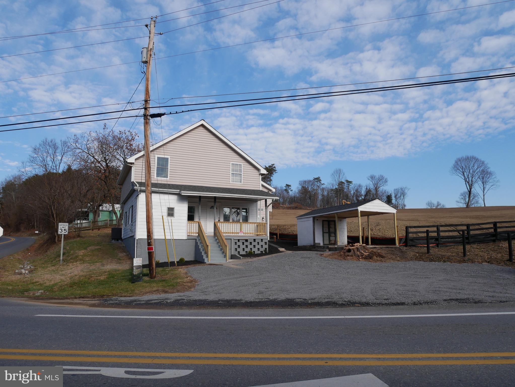 959 Golf Course Road Martinsburg, WV 25404 - Photo 3 of 35 a front view of a house with a garden