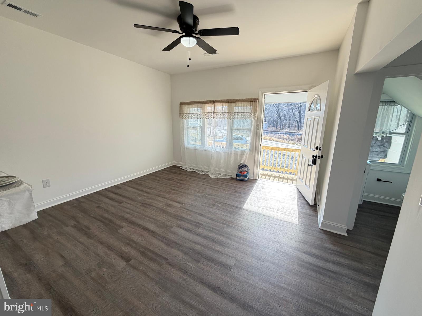 959 Golf Course Road Martinsburg, WV 25404 - Photo 9 of 35 an empty room with wooden floor and windows