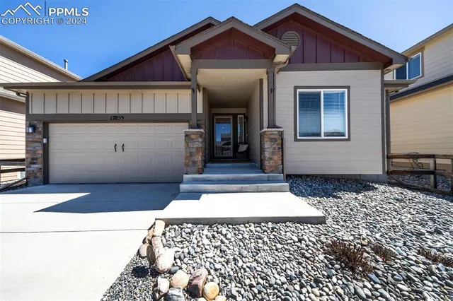a front view of a house with a large window