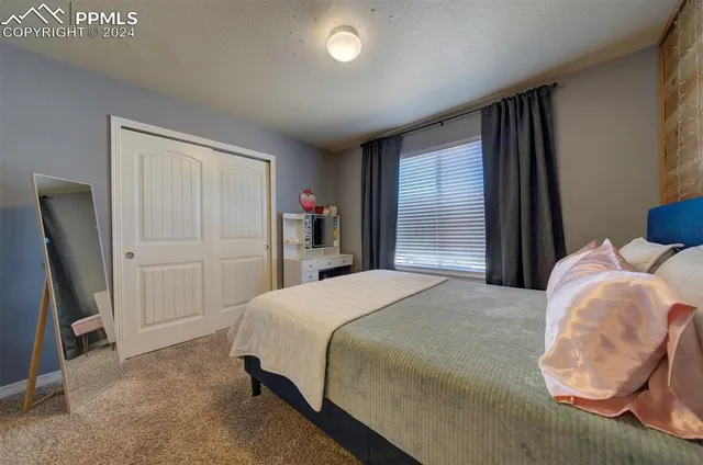 a bedroom with a bed and a dresser