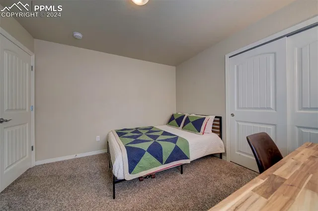 a bedroom with a bed a couch and a window