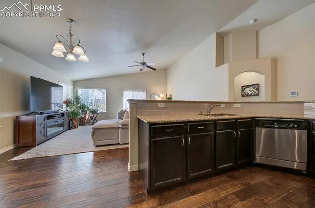 a kitchen with stainless steel appliances granite countertop a stove and a sink
