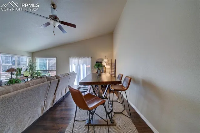 a view of a dining room with furniture and a window
