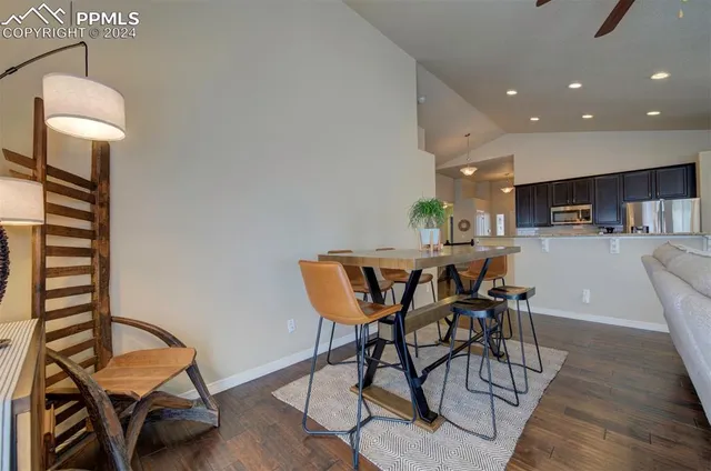 a dining room with furniture and wooden floor
