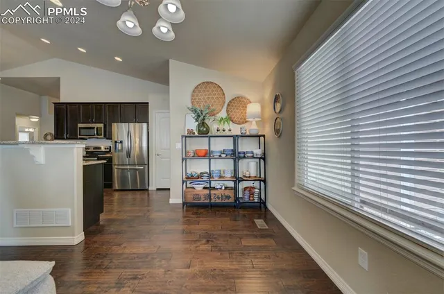 a kitchen with stainless steel appliances a refrigerator and a stove