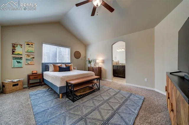 a bedroom with a bed lamp and a fireplace