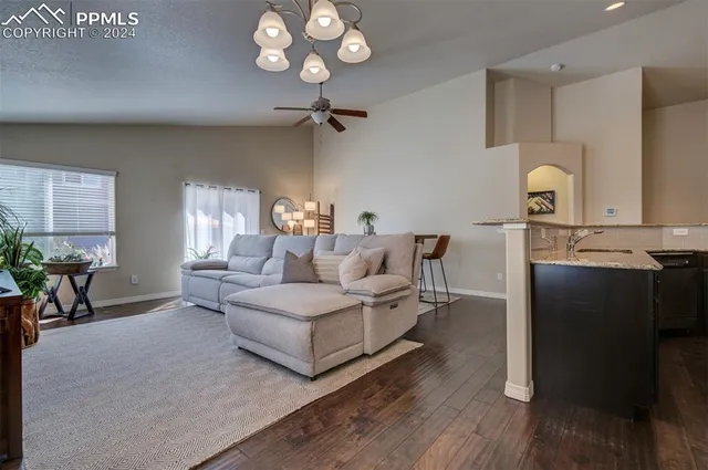 a living room with furniture and a chandelier