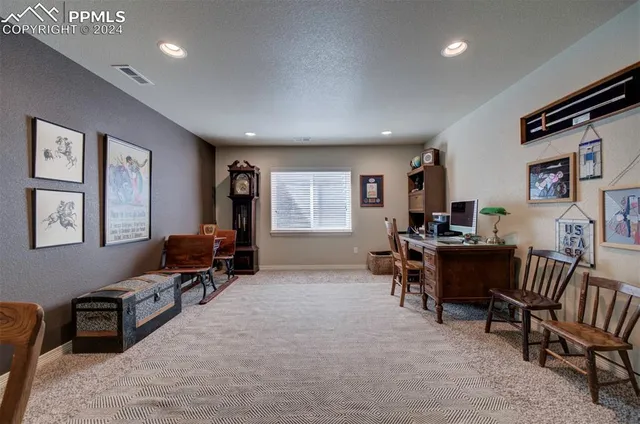 a livingroom with workspace and a couch