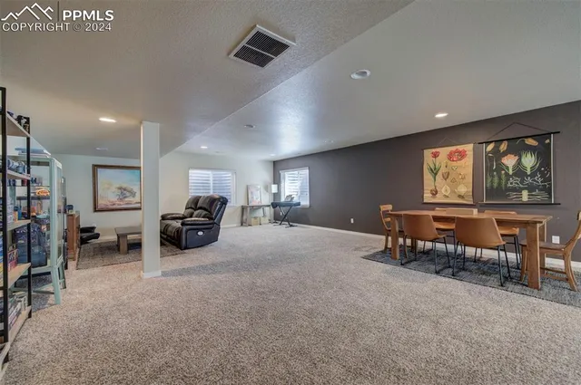 a living room with furniture a window and a flat screen tv