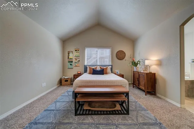 a bed room with a bed and window