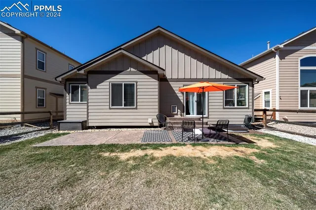 a front view of house with yard outdoor seating and pathway