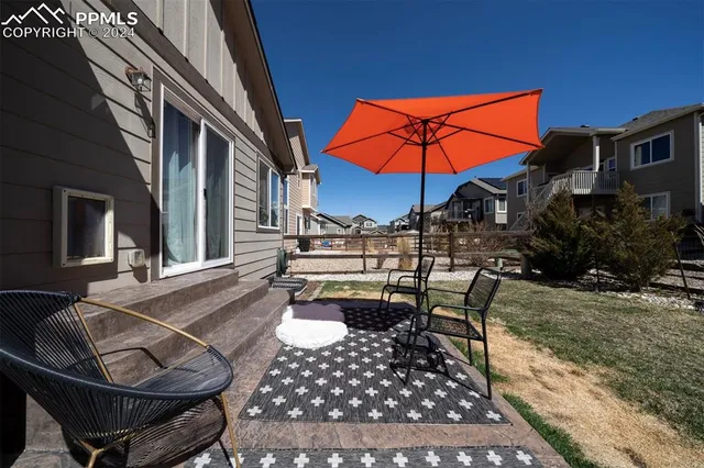 a patio with table and chairs