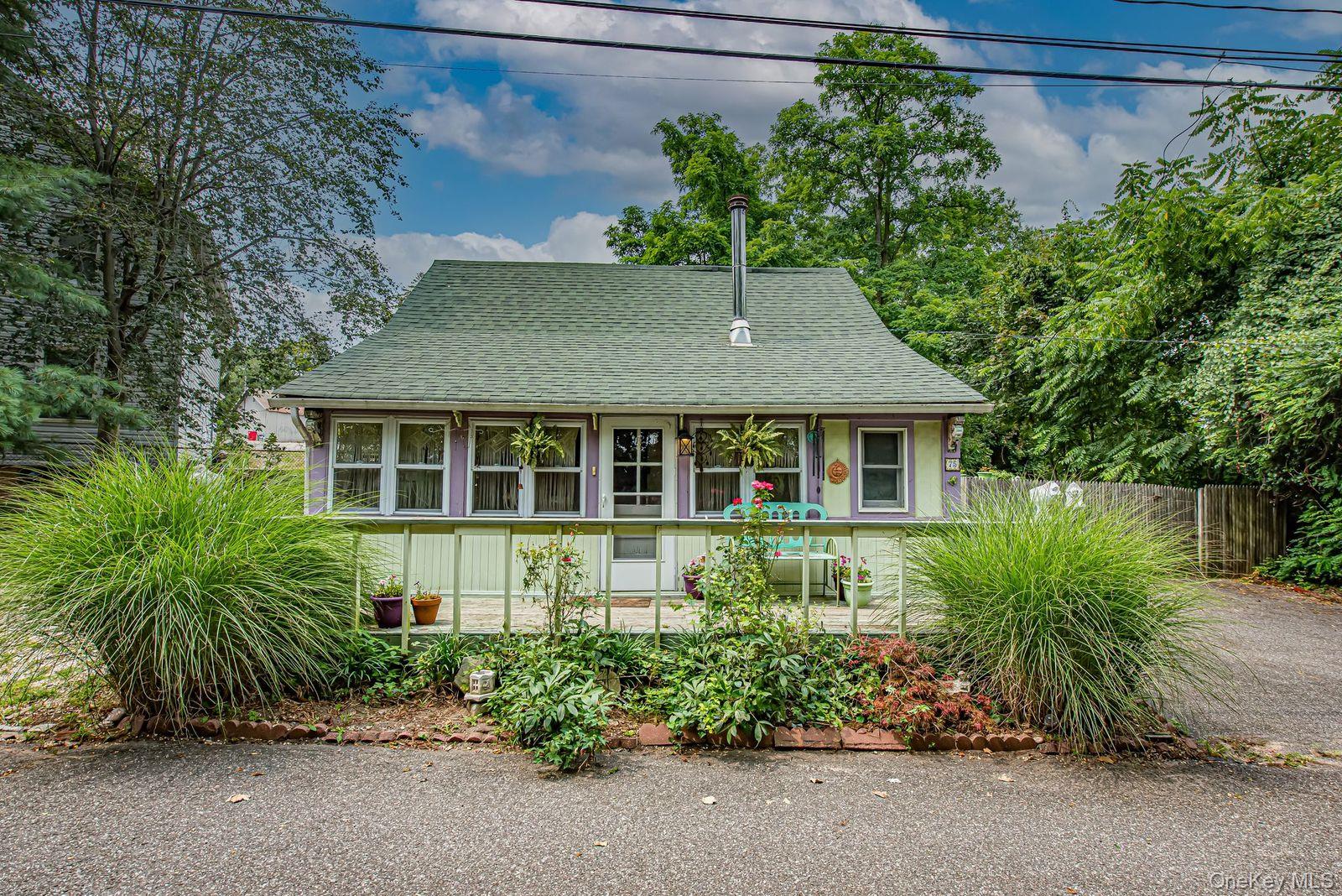 a front view of a house with a garden