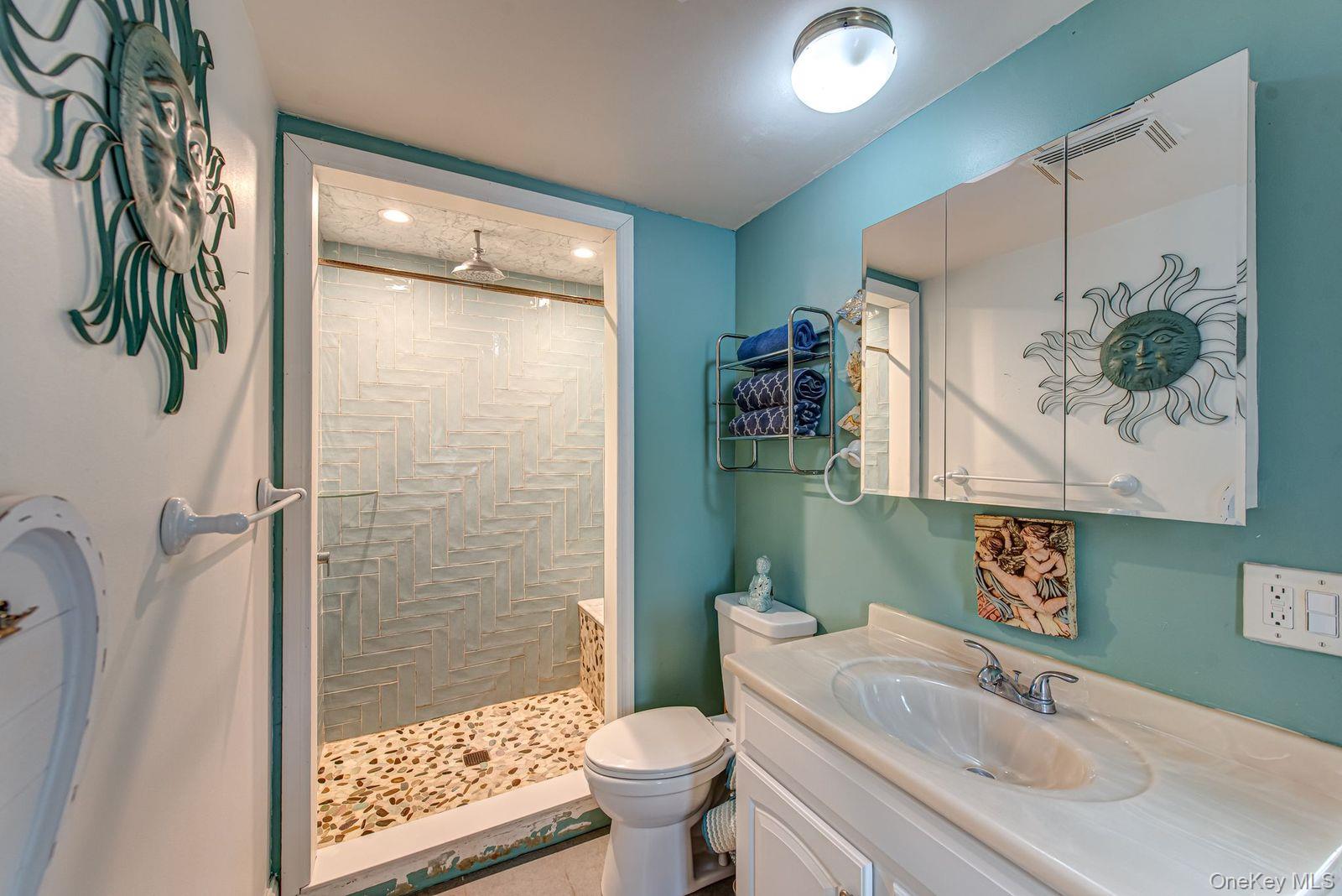 75 Upper Dock Road Kings Park, NY 11754 - Photo 14 of 30 a bathroom with a sink toilet and shower