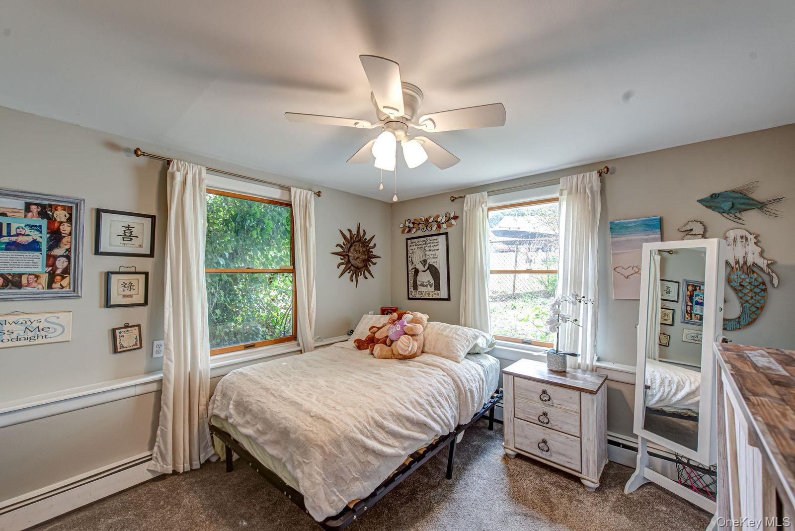 75 Upper Dock Road Kings Park, NY 11754 - Photo 15 of 30 a bedroom with a bed and a window