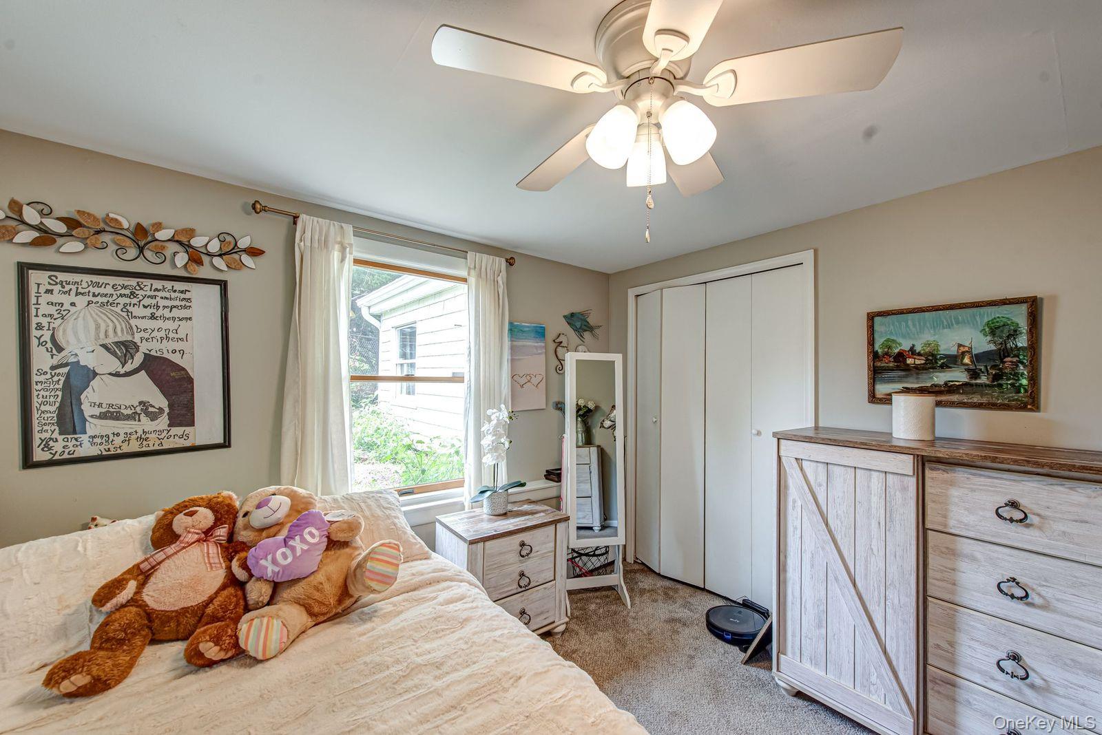 75 Upper Dock Road Kings Park, NY 11754 - Photo 16 of 30 a bedroom with furniture and a window