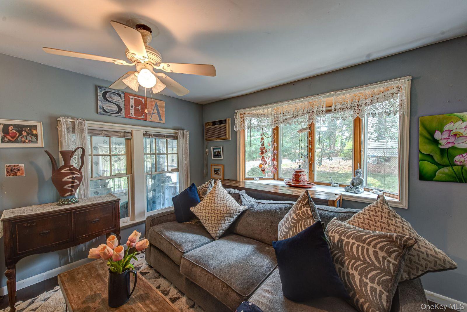 75 Upper Dock Road Kings Park, NY 11754 - Photo 5 of 30 a living room with furniture and floor to ceiling windows