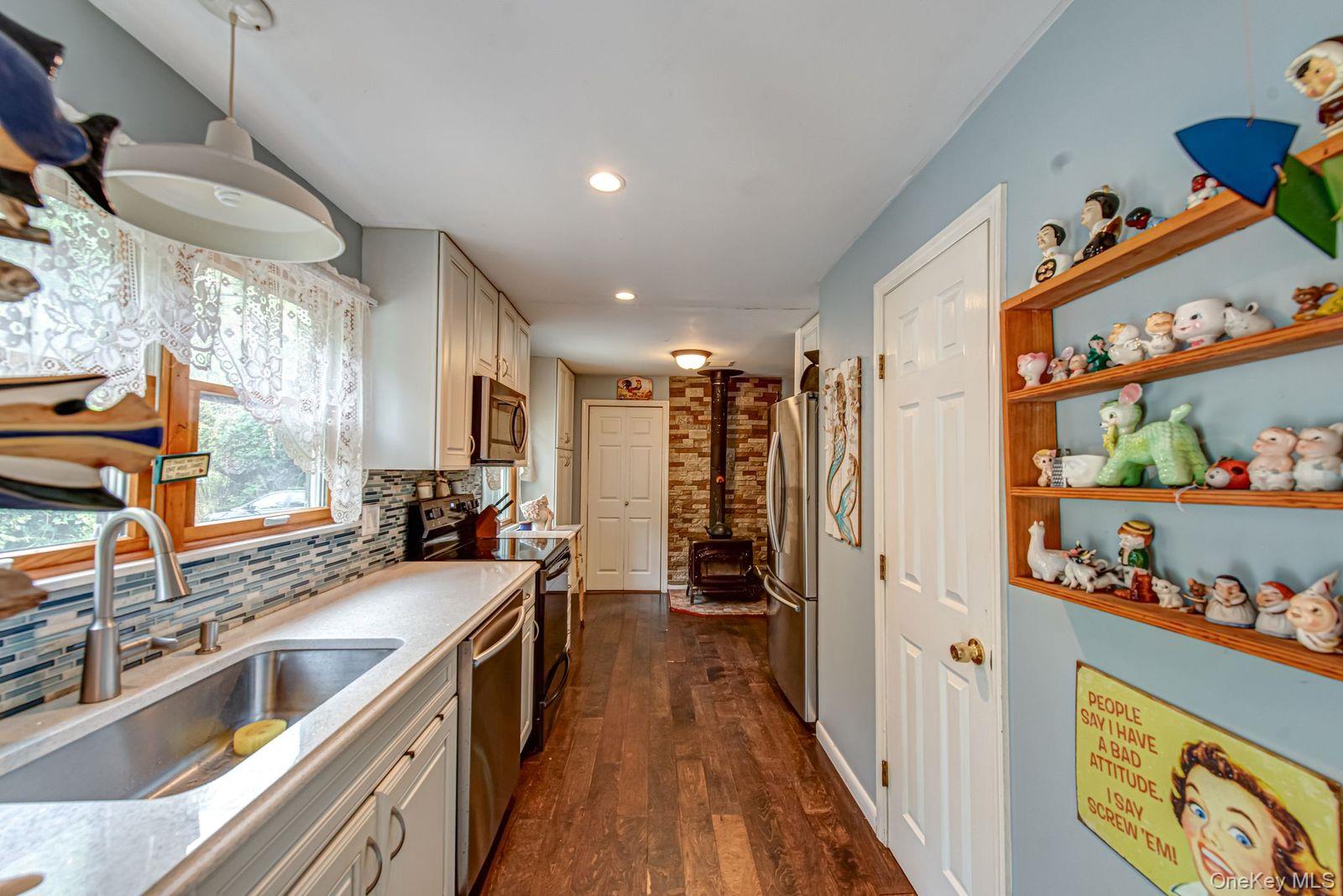 75 Upper Dock Road Kings Park, NY 11754 - Photo 10 of 30 a kitchen with stainless steel appliances a sink stove and refrigerator
