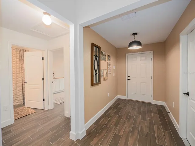 a view of a hallway with wooden floor