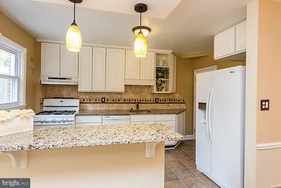 6112 Mt Ridge Road Baltimore, MD 21228 - Photo 11 of 30 a kitchen with stainless steel appliances granite countertop a refrigerator a stove and a sink