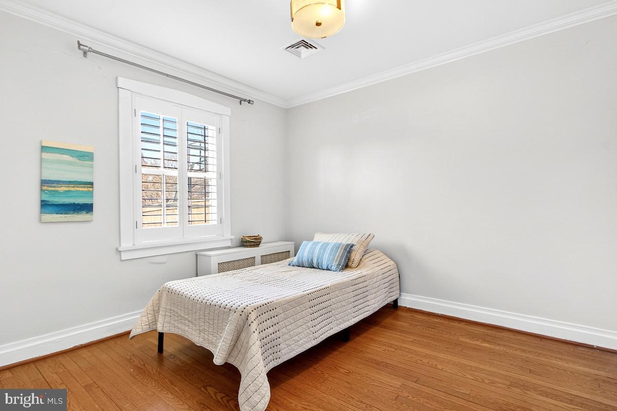 100 East Maple Street Alexandria, VA 22301 - Photo 41 of 114 a bedroom with a bed and wooden floor