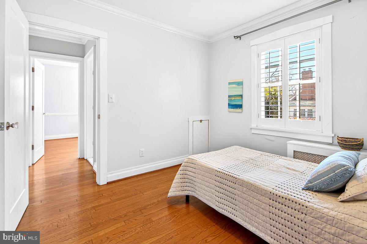 100 East Maple Street Alexandria, VA 22301 - Photo 42 of 114 a bedroom with a bed and wooden floor