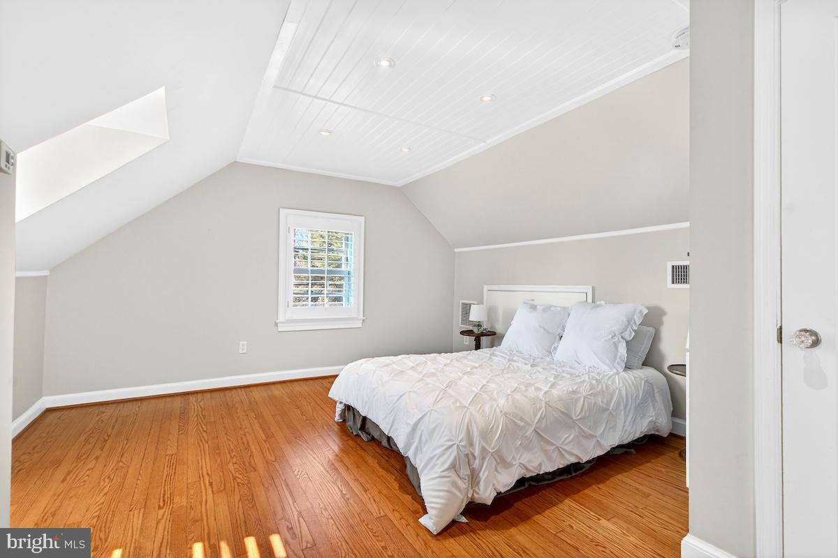 100 East Maple Street Alexandria, VA 22301 - Photo 44 of 114 a bedroom with a bed and wooden floor