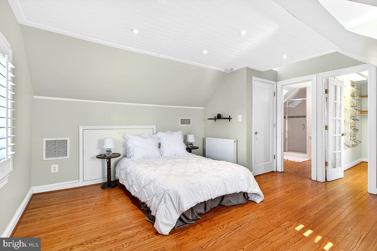 100 East Maple Street Alexandria, VA 22301 - Photo 47 of 114 a bedroom with a bed and wooden floor