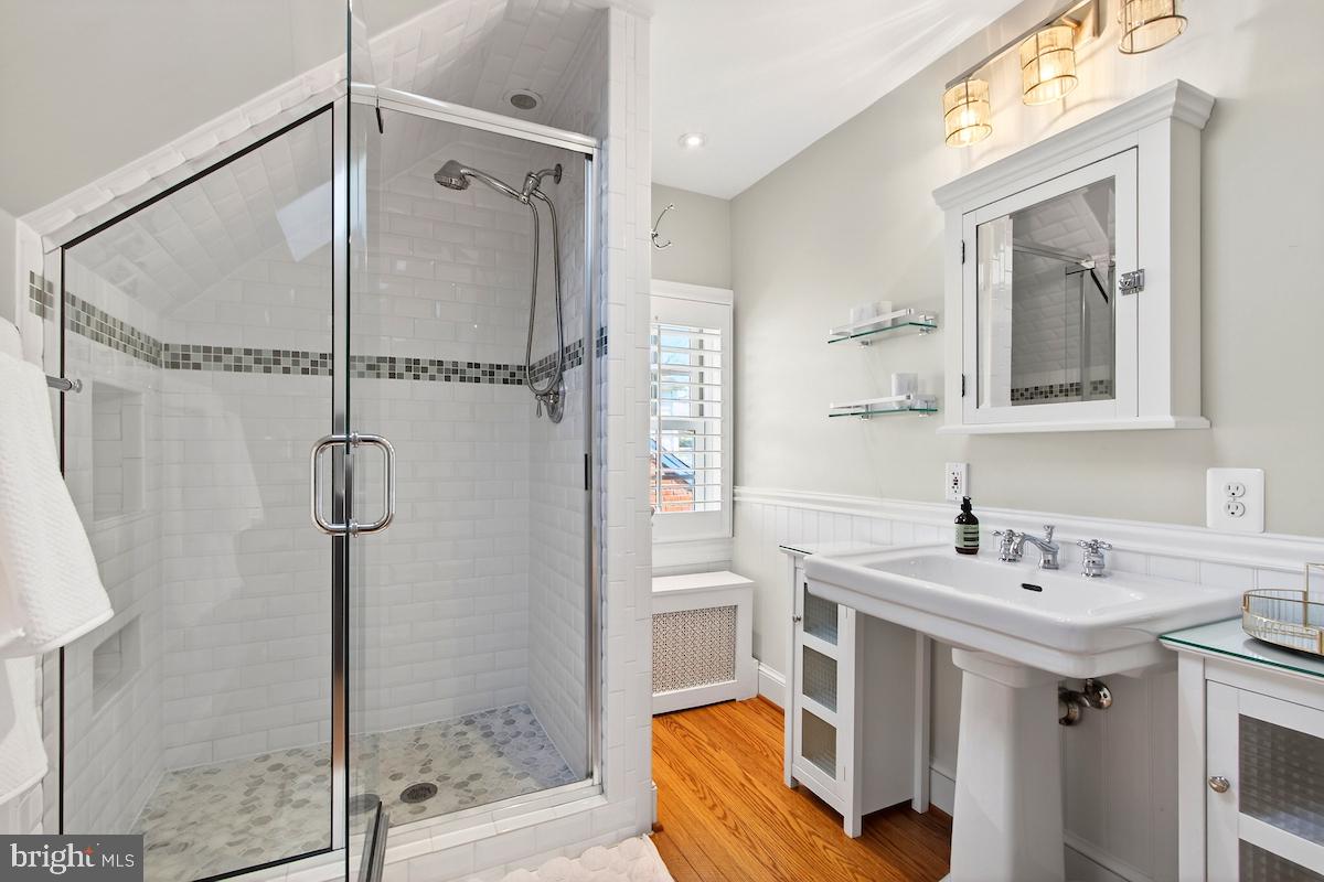 100 East Maple Street Alexandria, VA 22301 - Photo 53 of 114 a bathroom with a sink mirror and a shower