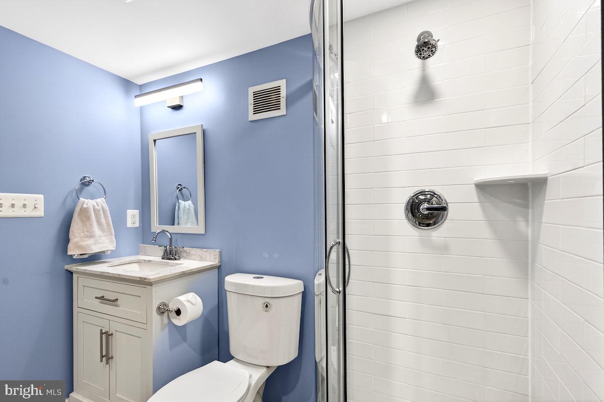 100 East Maple Street Alexandria, VA 22301 - Photo 83 of 114 a bathroom with a granite countertop toilet sink and mirror