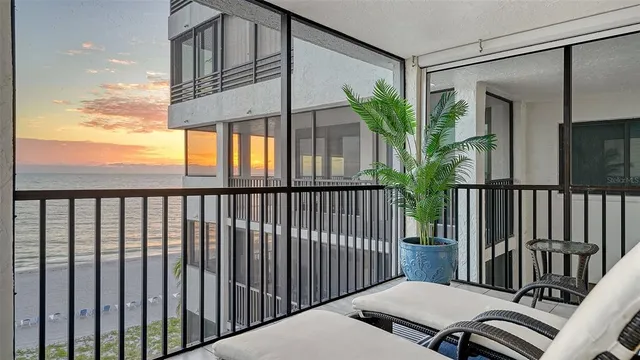 a view of a dining room with furniture large windows and wooden floor